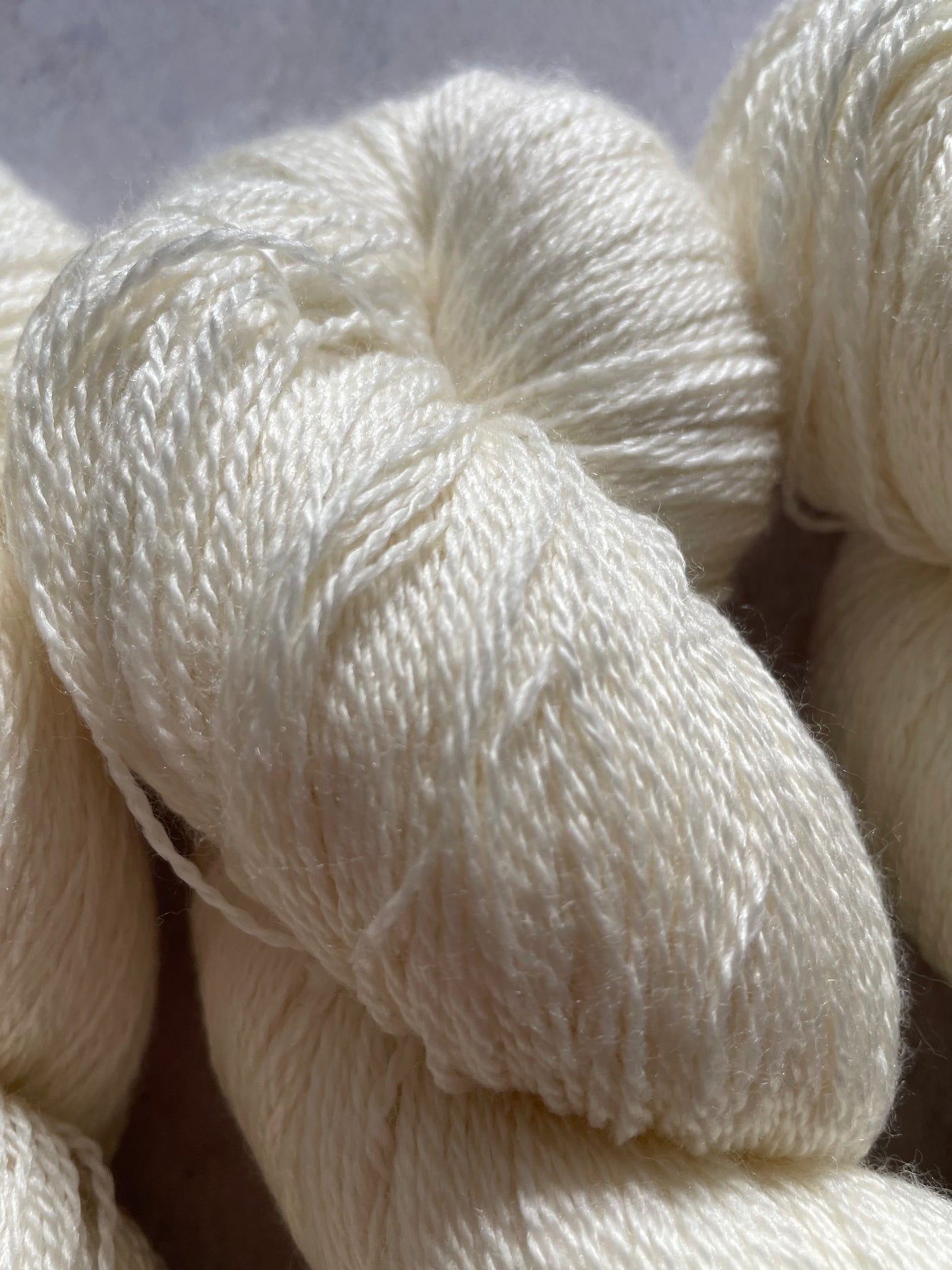 Close up of undyed merino and silk lace yarn