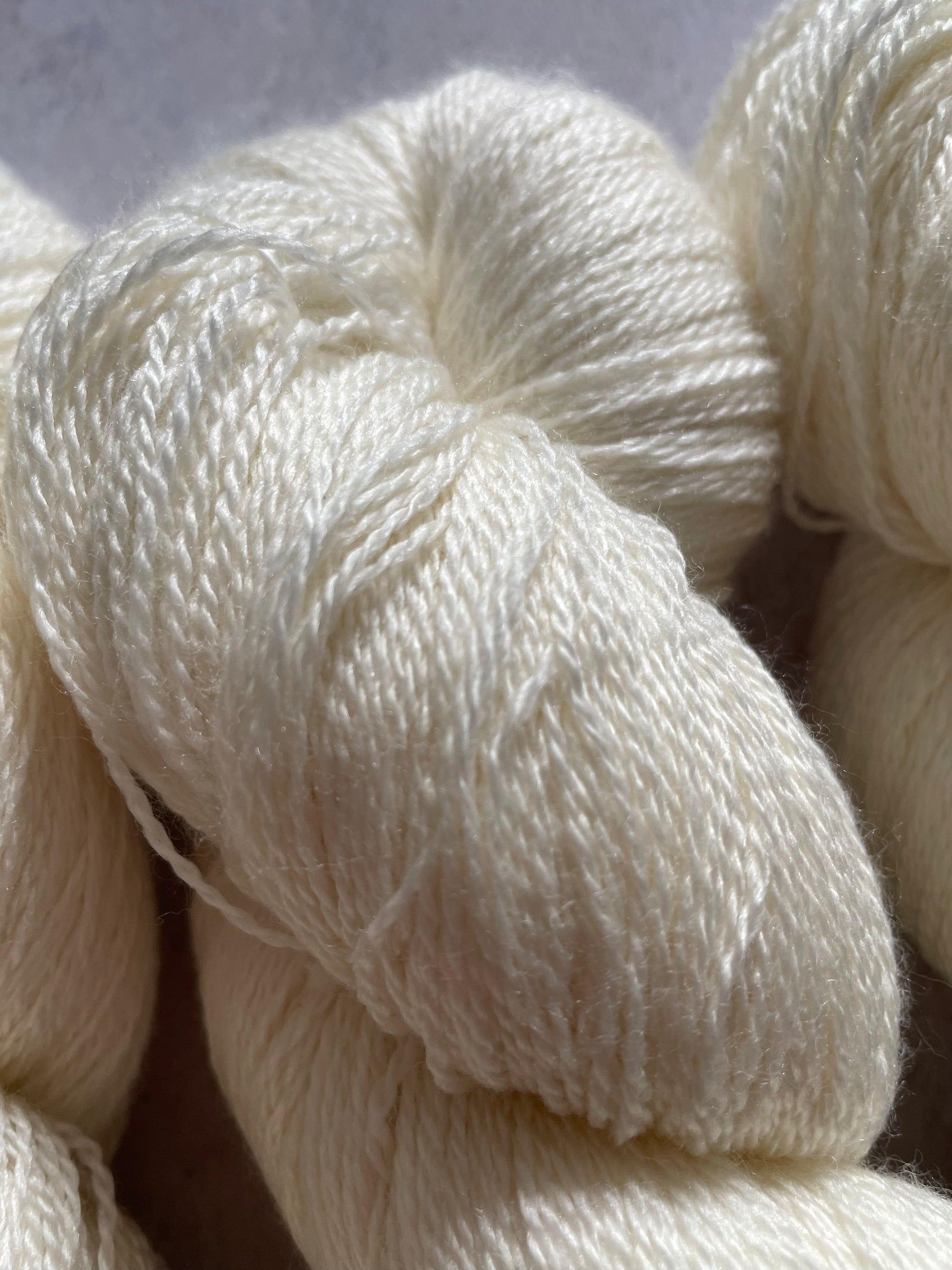 Close up of undyed merino and silk lace yarn