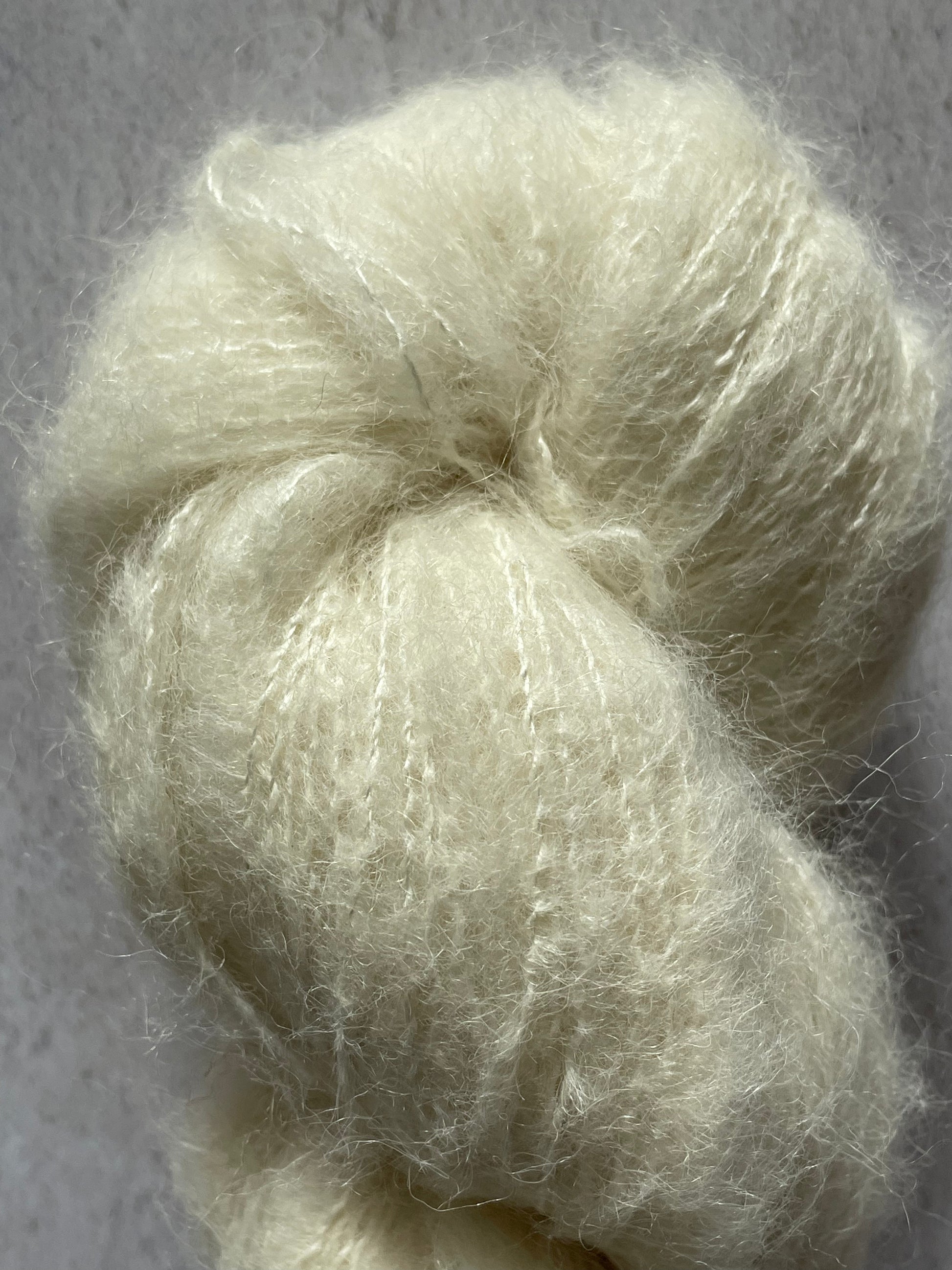A close up of the soft and fluffy cream yarn