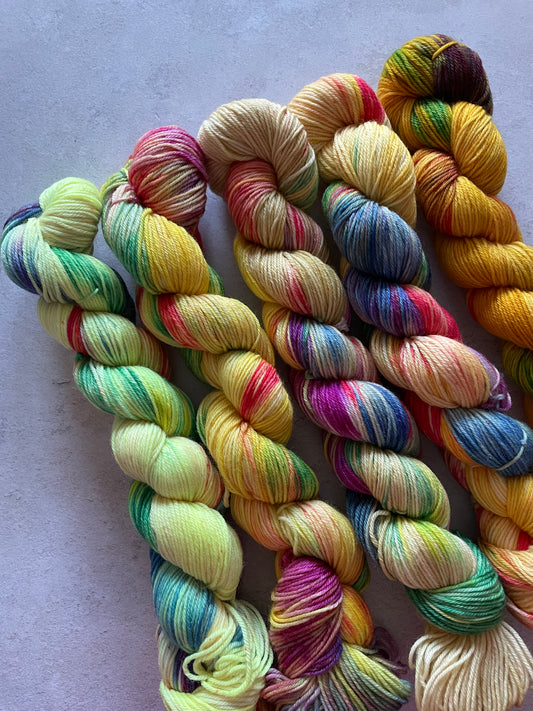 5 skeins of multicoloured and yellow yarn in different shades