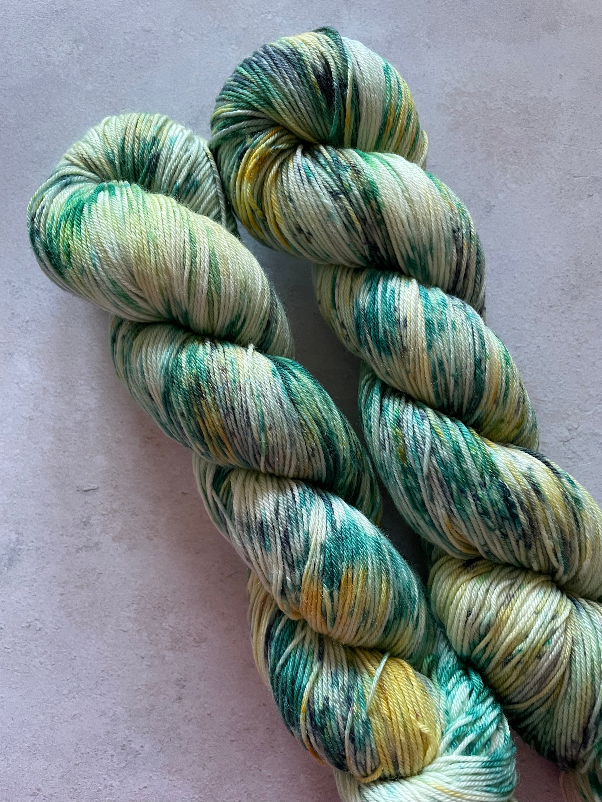 2 skeins speckled with green yellow and grey