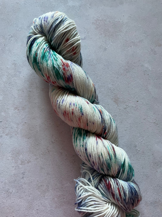 Skein of yarn speckled with teal red and navy