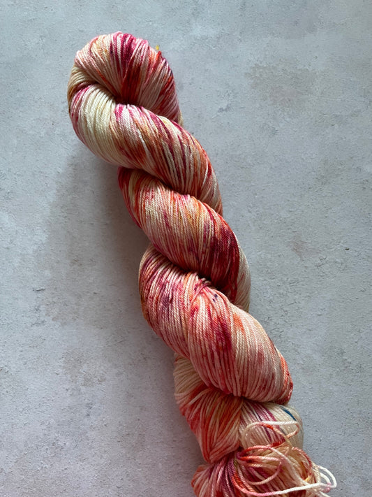 1 skein of yarn speckled with shades of red