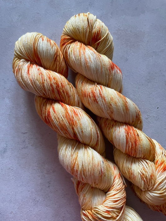 2 skeins of orange speckled yarn