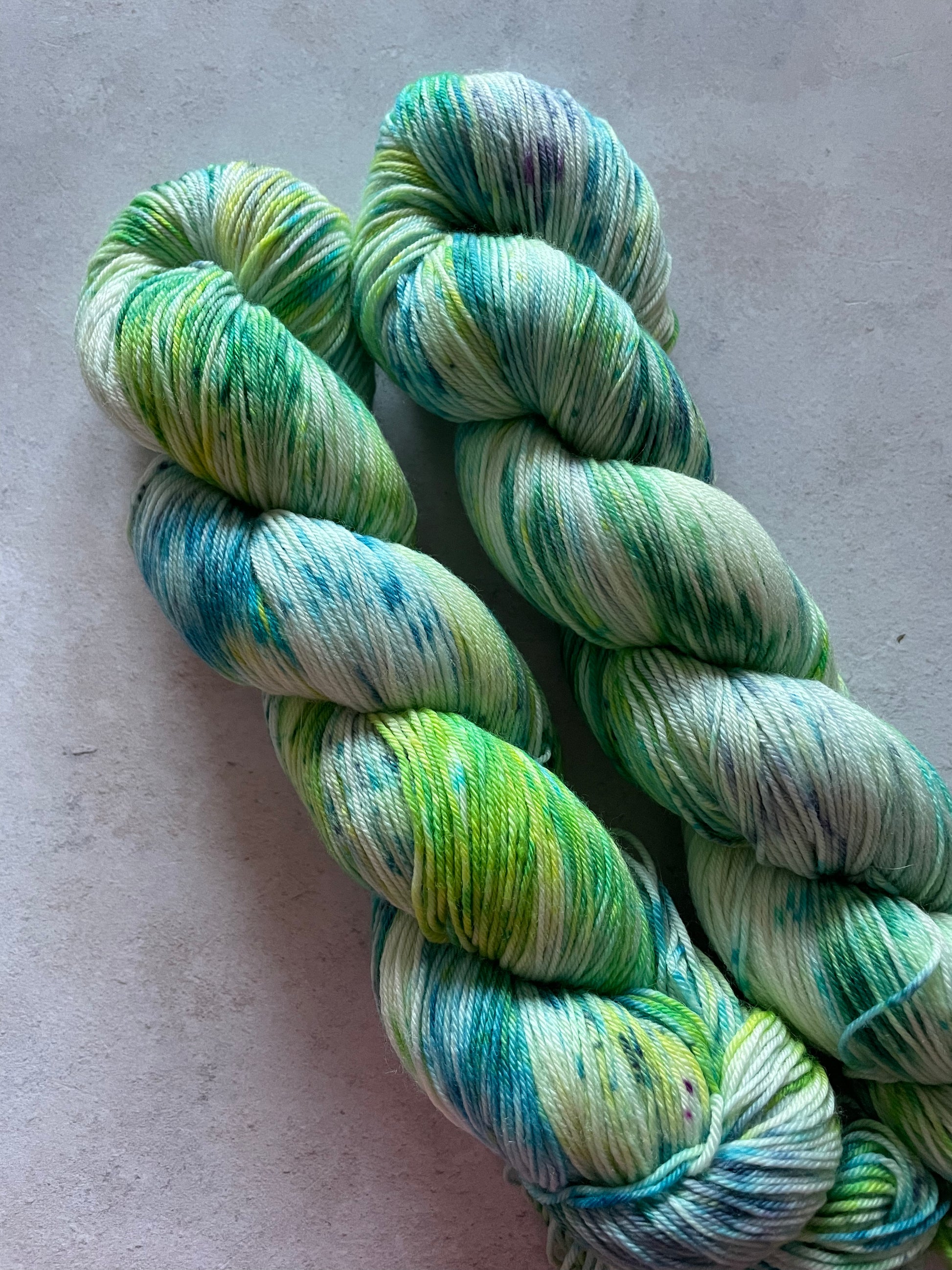 2 skeins of green and turquoise yarn