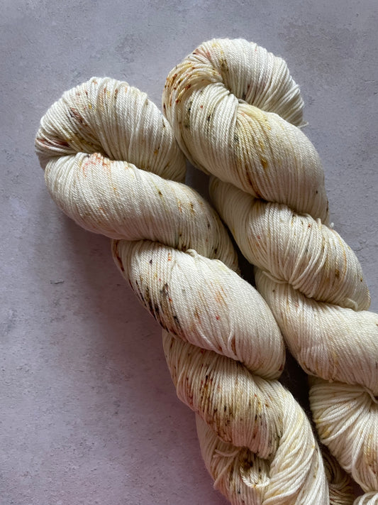2 skeins of yarn lightly speckled with gold
