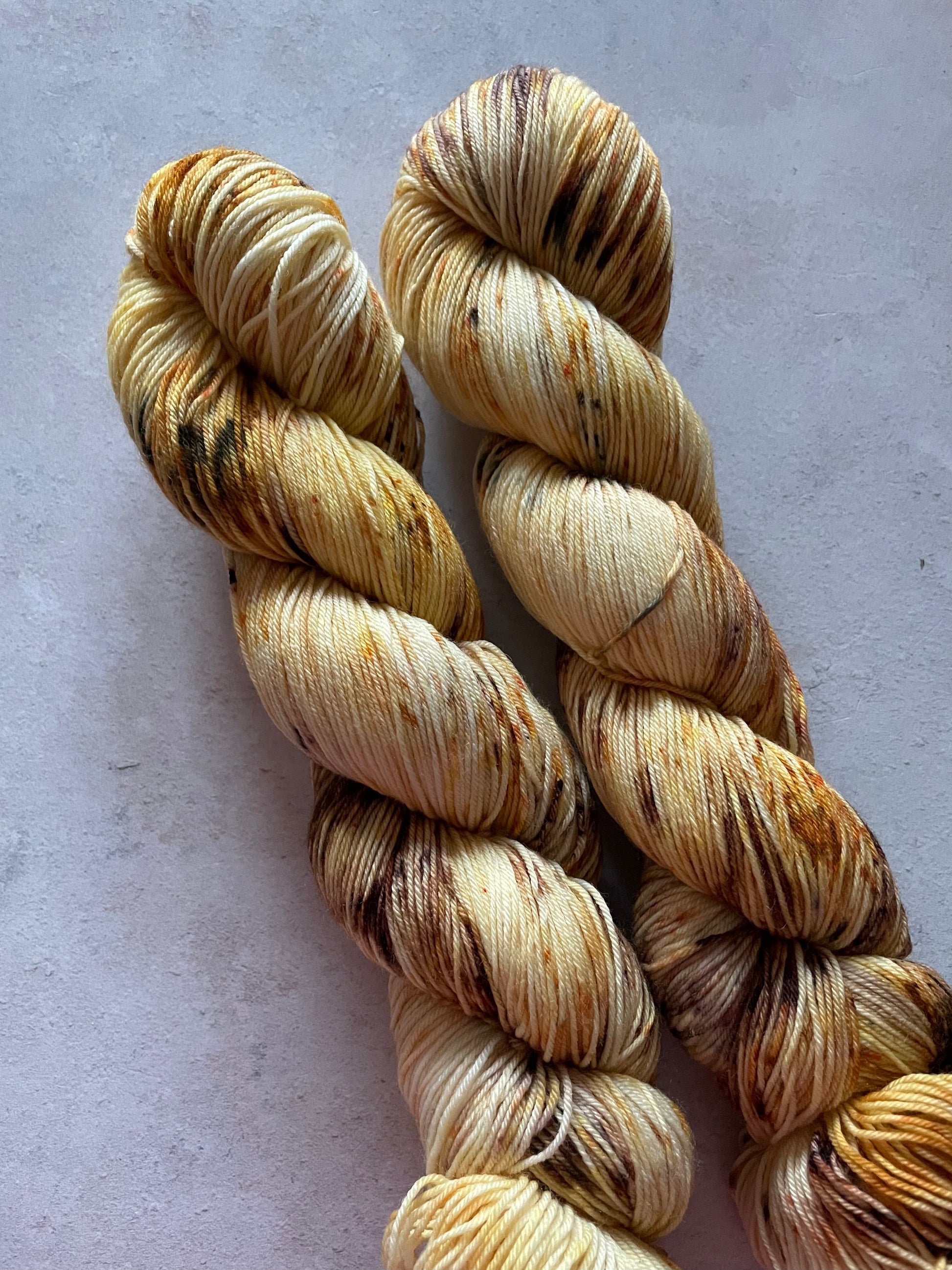 2 skeins of yarn in golds and browns