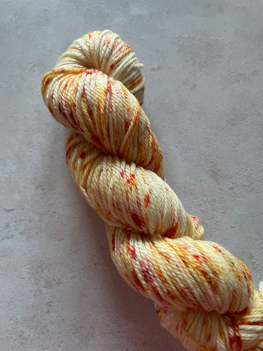 Aran yarn with orange and red speckles