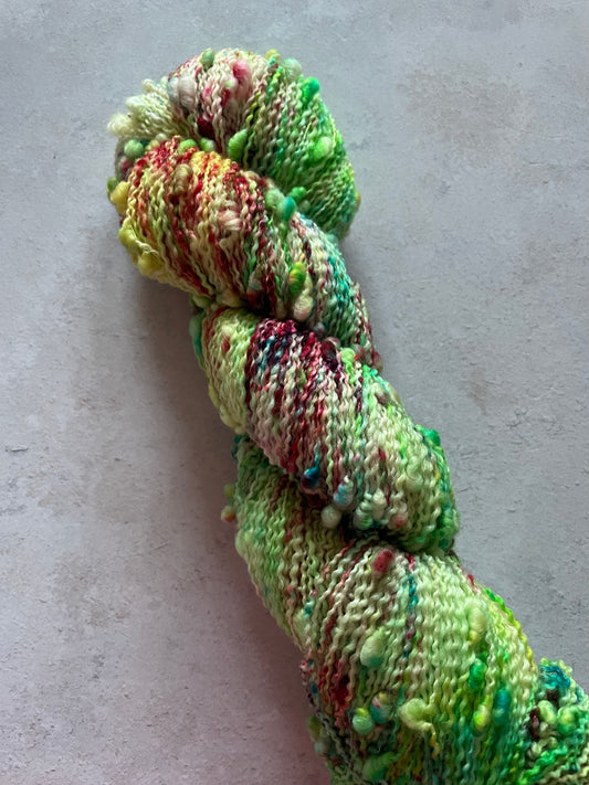 Textured slub skein with greens and reds