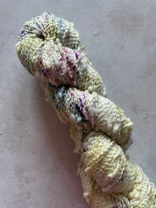 Textured slub yarn with speckles of purple blue and green