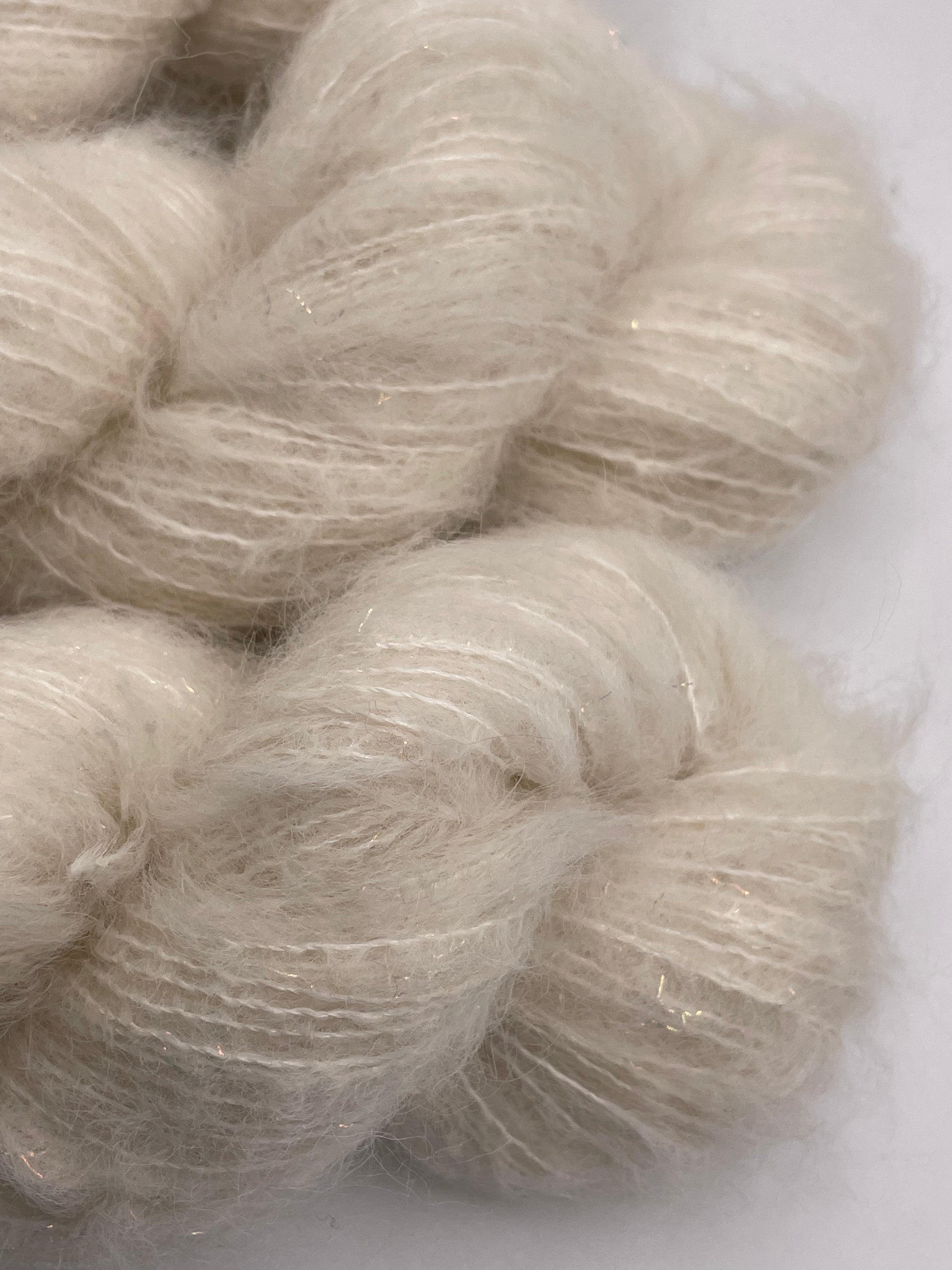 Skeins of the suri alpaca and silk cloud base with iridescent stellina