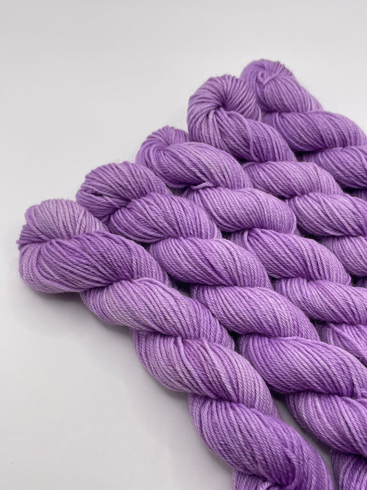 Purple yarn mini skeins on a white background