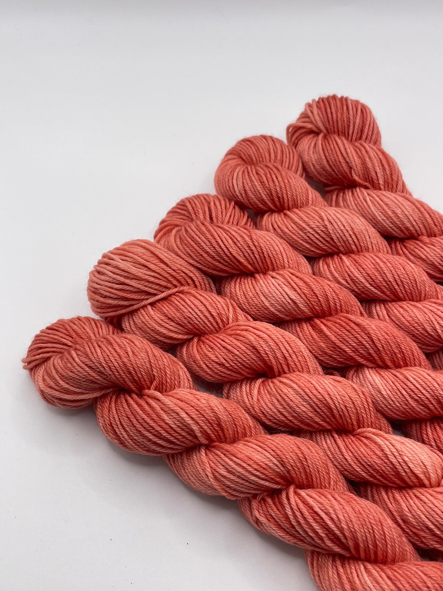 Red yarn mini skeins on a white background
