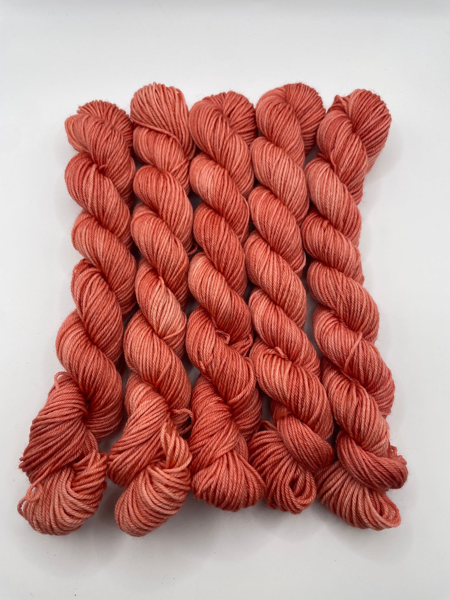 Red yarn mini skeins on a white background
