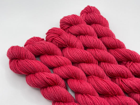 Red yarn mini skeins on a white background