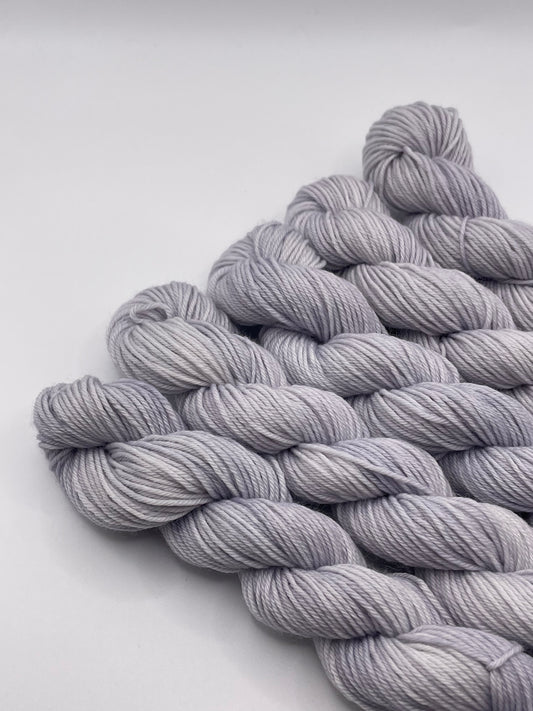 Grey yarn mini skeins on a white background